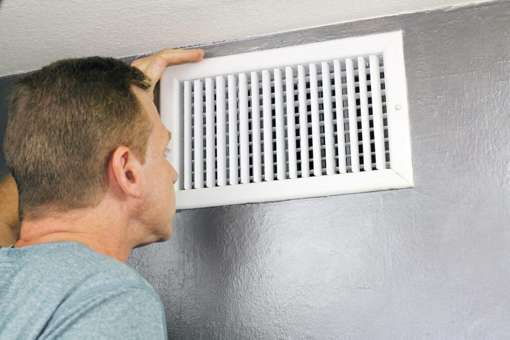 Homeowner looking into ac vent for mold